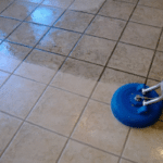 Image of someone cleaning tiled and grouted floor