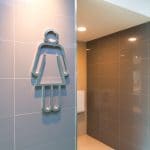 modern public woman toilet sign on granite wall tile at the entrance