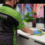 "The Importance of Regular Office Cleaning – A professional cleaner disinfecting an office workspace."