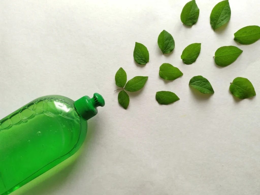 Eco-Friendly Liquid Soap Bottle with Green Leaves - Natural Cleaning Concept