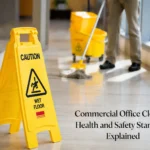 Commercial cleaner mopping office floor with wet floor caution sign for workplace health and safety standards
